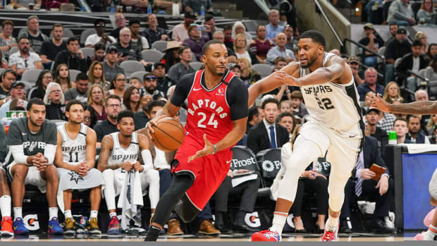 Jan 26, 2020; San Antonio, Texas, USA; Toronto Raptors guard Norman Powell (24) moves around San Antonio Spurs forward Rudy Gay (22) in the second half at the AT&T Center. Mandatory Credit: Daniel Dunn-USA TODAY Sports